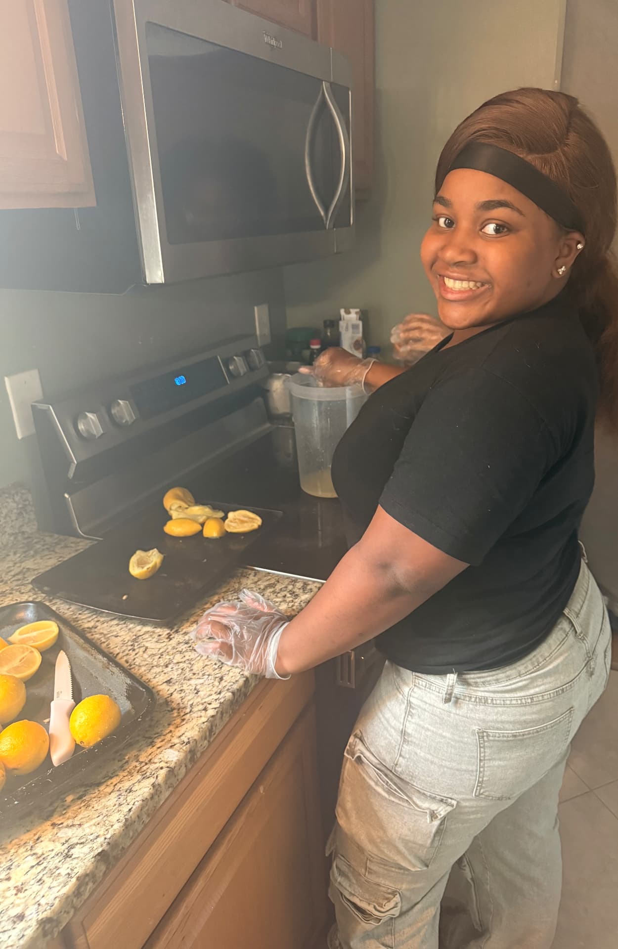 Sister squeezing fresh lemons in the kitchen